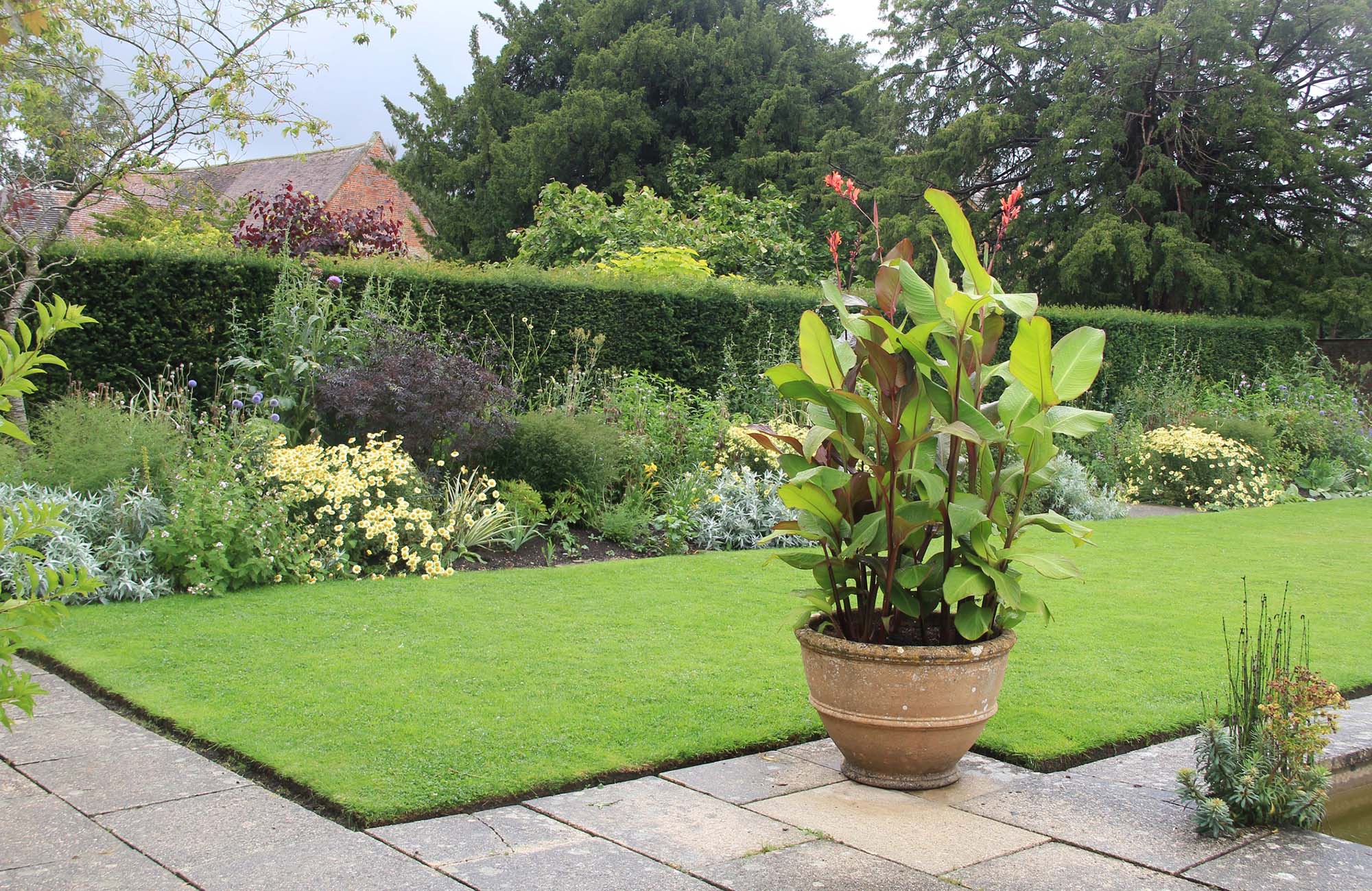Tintinhull Gardens are located near the town of Yeovil in the county of Somerset, UK. The house dates back to the 17th Century but the garden is 20th Century. it is in the care of the National Trust and open to the public. The garden is in the Arts and Crafts style and was designed by Mrs Phyllis Reiss and split into 7 distinctive rooms.